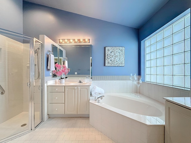 bathroom with tile patterned flooring, vanity, and independent shower and bath