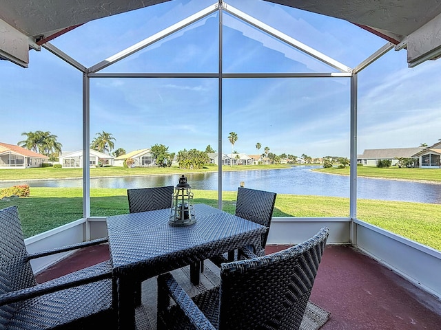 sunroom / solarium featuring a water view