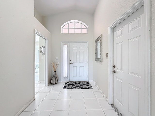 tiled entrance foyer with vaulted ceiling