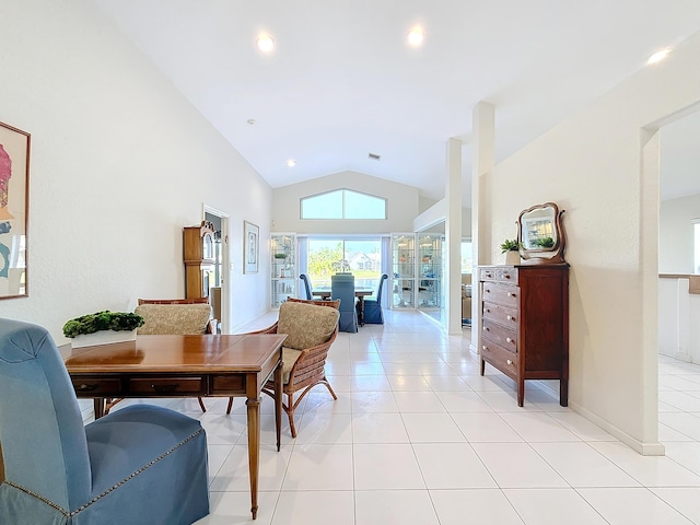 dining room with lofted ceiling and light tile patterned floors