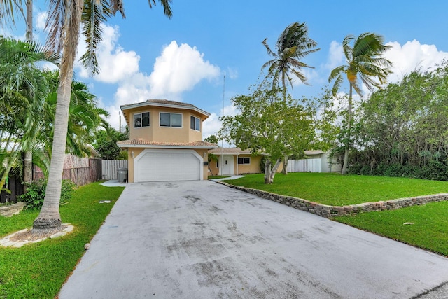 view of front of house featuring an attached garage, fence, concrete driveway, stucco siding, and a front lawn