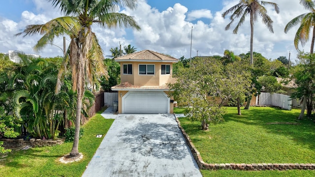 view of front facade with concrete driveway, a tile roof, fence, a front lawn, and stucco siding