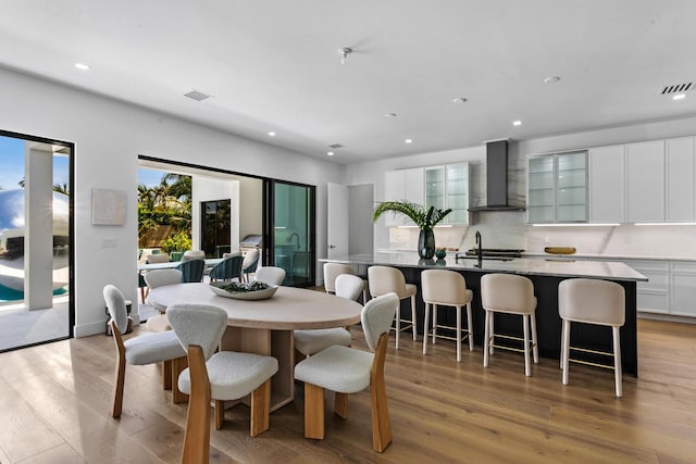 dining area with sink and light hardwood / wood-style flooring