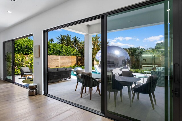 doorway to outside featuring light hardwood / wood-style flooring and a wealth of natural light