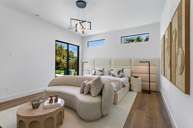 bedroom featuring light hardwood / wood-style flooring and an inviting chandelier