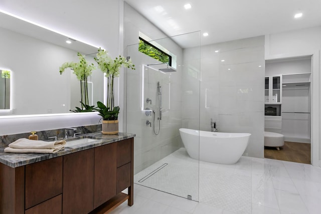 bathroom featuring vanity and shower with separate bathtub