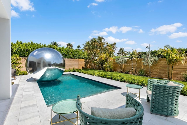 view of swimming pool with a patio area