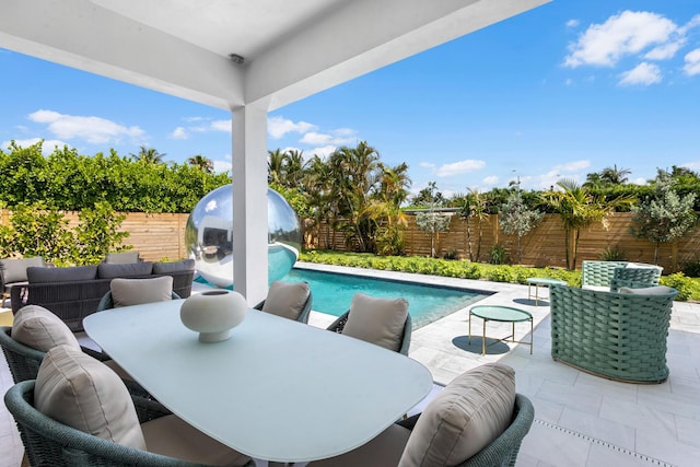 view of pool with outdoor lounge area and a patio