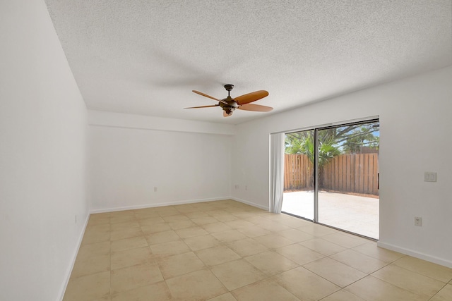 empty room featuring ceiling fan and a textured ceiling