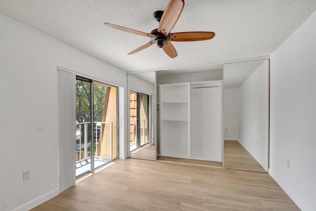 unfurnished bedroom featuring light hardwood / wood-style flooring, ceiling fan, access to exterior, a textured ceiling, and a closet