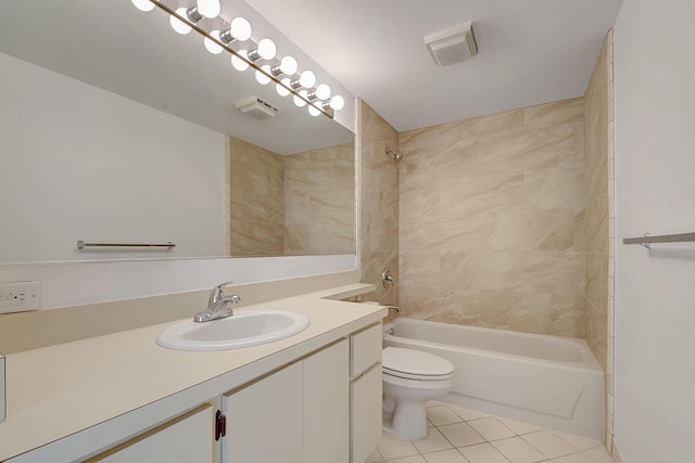 full bathroom featuring tile patterned floors, vanity, tiled shower / bath, and toilet