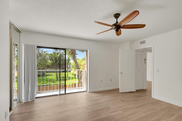 unfurnished room featuring a textured ceiling, light wood-type flooring, and ceiling fan