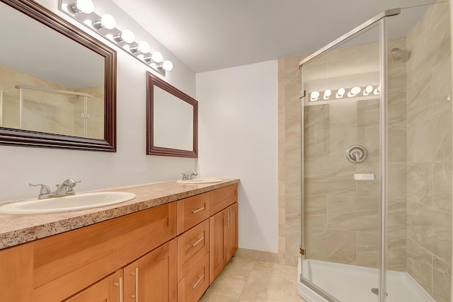 bathroom with tile patterned floors, a shower with door, and vanity