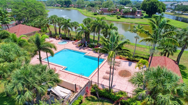 view of pool featuring a patio area and a water view