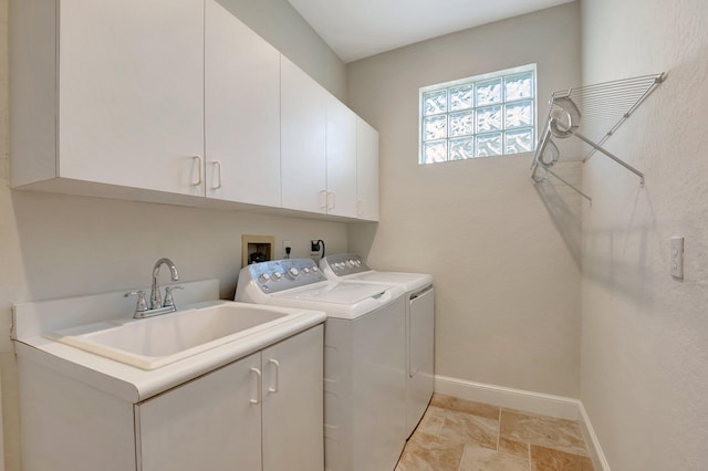 laundry room featuring cabinets, independent washer and dryer, and sink