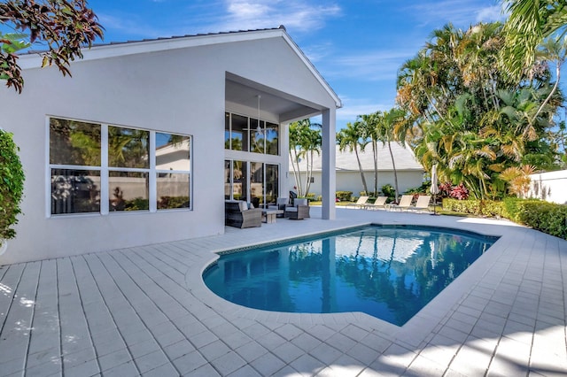 view of pool featuring an outdoor living space and a deck