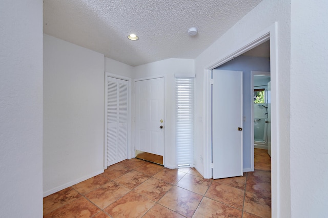 foyer with a textured ceiling