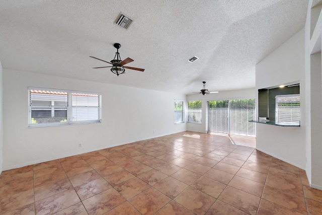 empty room with ceiling fan and light tile patterned flooring