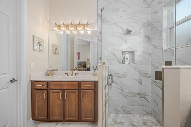 bathroom featuring a shower with shower door and vanity