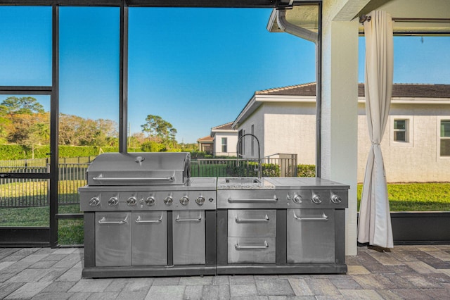 view of patio with exterior kitchen, sink, and a grill