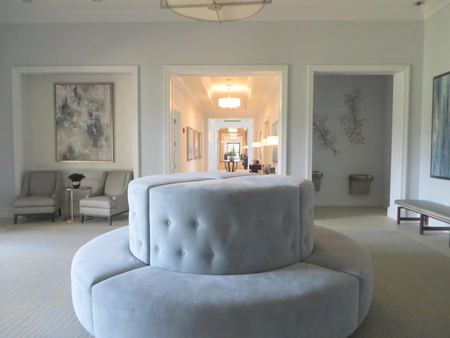 carpeted living room with crown molding