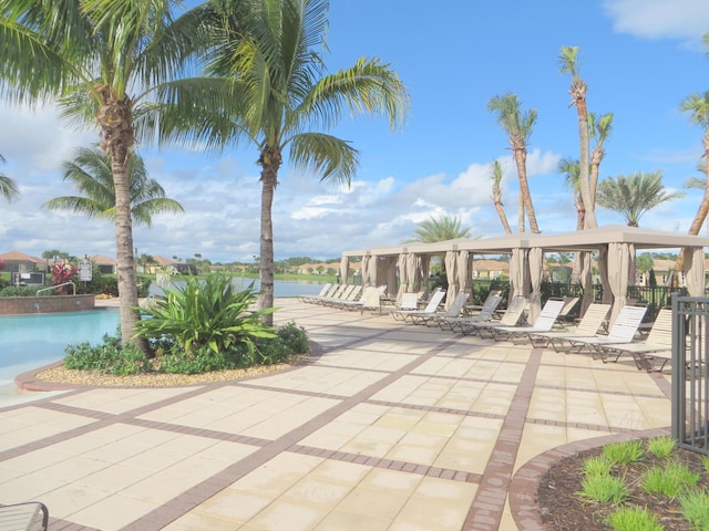 view of community featuring a patio area, a water view, and a pool