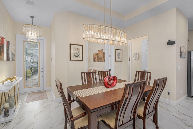 dining space with a notable chandelier