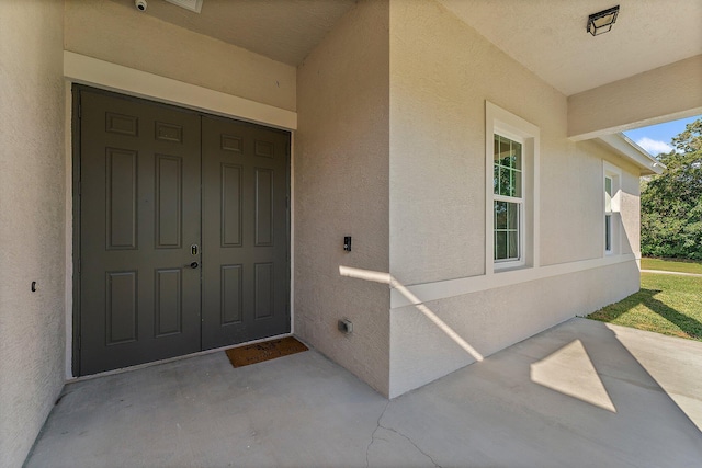 view of exterior entry featuring a porch