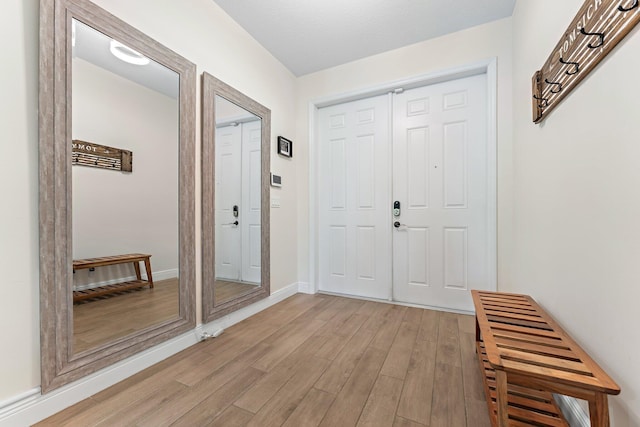 foyer entrance with light hardwood / wood-style floors