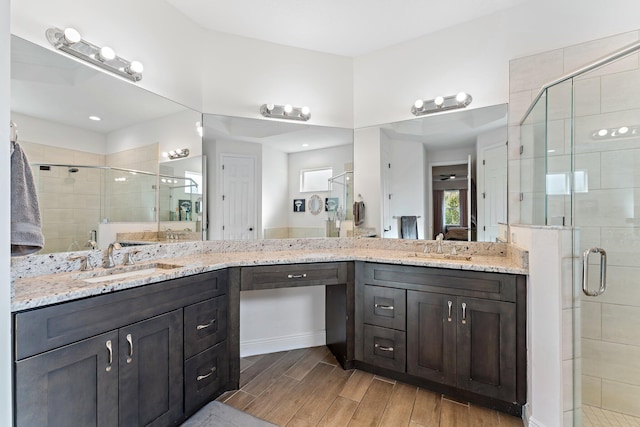 bathroom featuring vanity and an enclosed shower