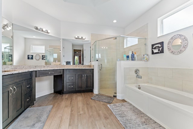 bathroom with separate shower and tub, hardwood / wood-style floors, and vanity