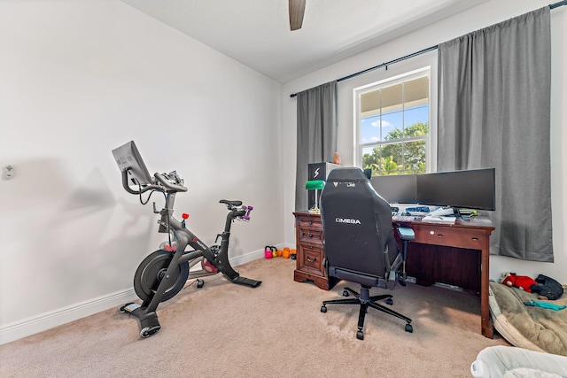 carpeted office space with ceiling fan and vaulted ceiling