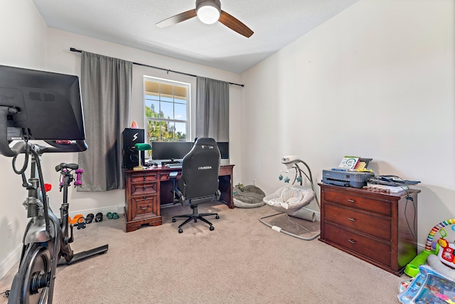 carpeted home office with ceiling fan