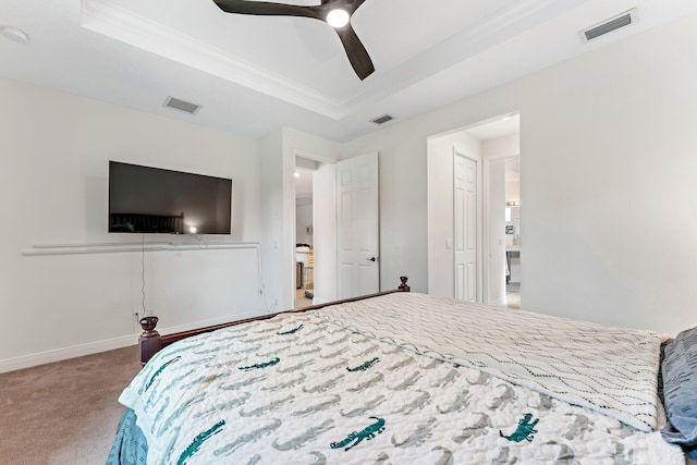 carpeted bedroom with ceiling fan, a raised ceiling, and crown molding