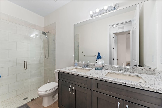 bathroom with hardwood / wood-style floors, vanity, toilet, and walk in shower