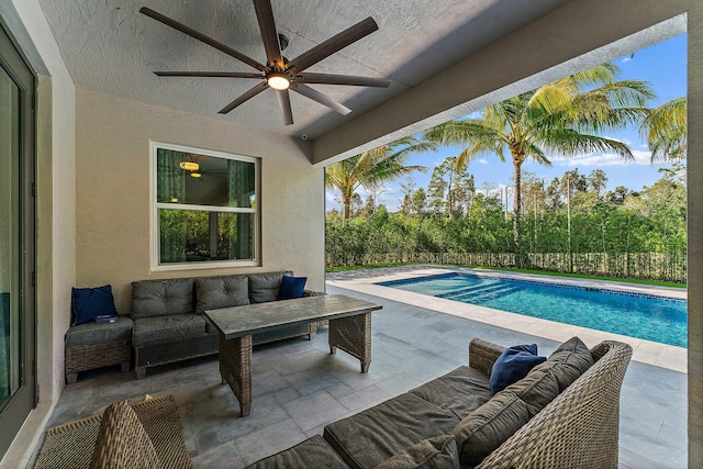 view of pool featuring outdoor lounge area, ceiling fan, and a patio area