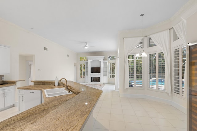 kitchen featuring decorative light fixtures, ceiling fan with notable chandelier, white dishwasher, white cabinetry, and sink