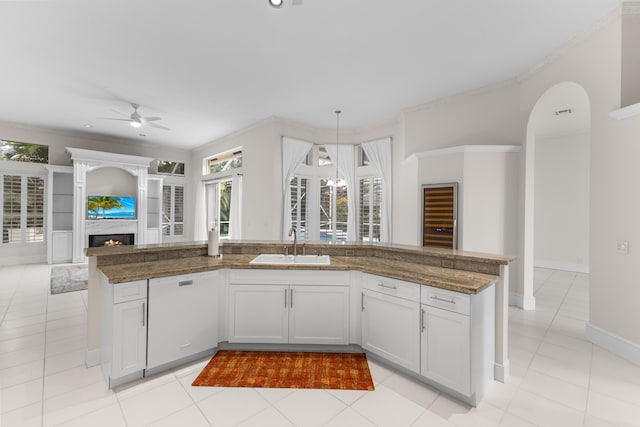 kitchen featuring sink, white cabinetry, ceiling fan, white dishwasher, and hanging light fixtures