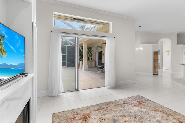 unfurnished living room featuring a notable chandelier and light tile patterned floors