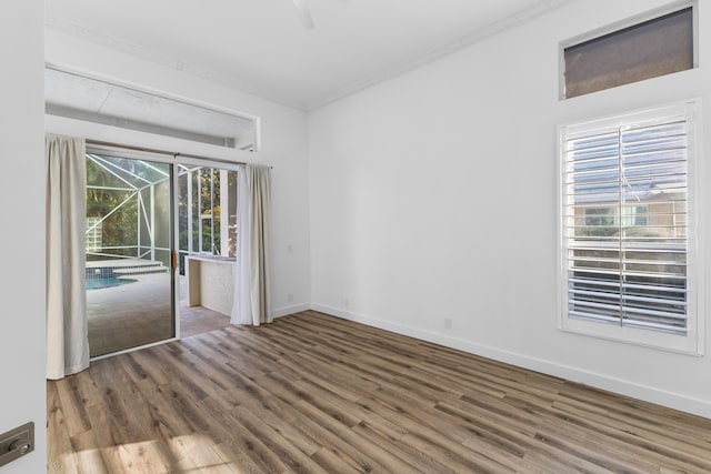 spare room with crown molding and hardwood / wood-style floors