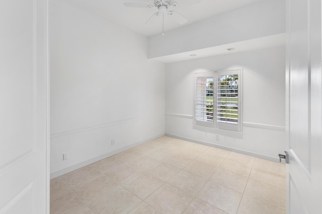 empty room with ceiling fan and light tile patterned flooring