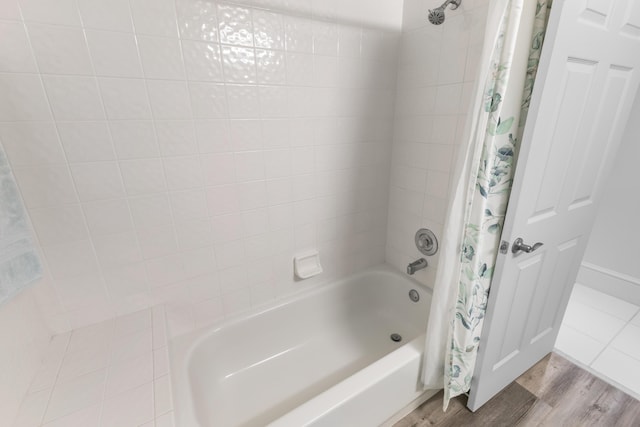 bathroom featuring shower / tub combo and hardwood / wood-style floors