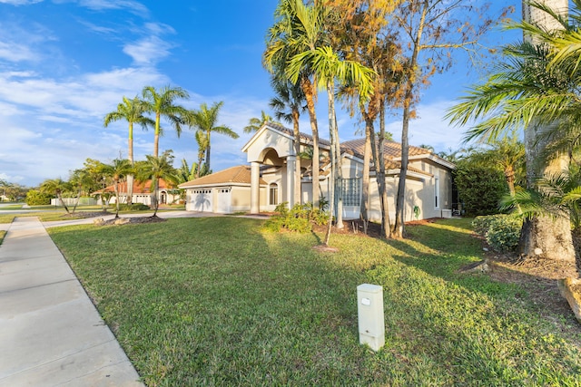 view of front of property with a front lawn and a garage