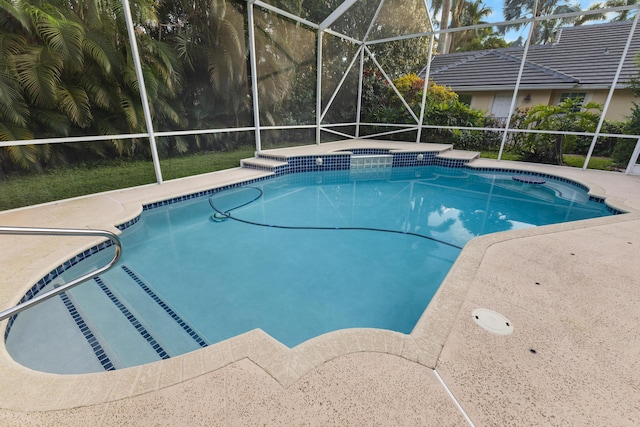 view of swimming pool with glass enclosure