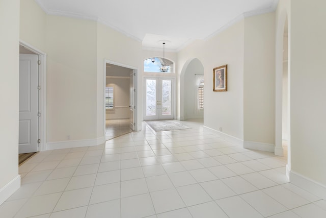 tiled foyer entrance with french doors and crown molding