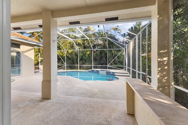 view of pool featuring a patio and glass enclosure