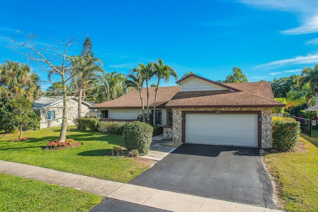 single story home with a garage and a front lawn