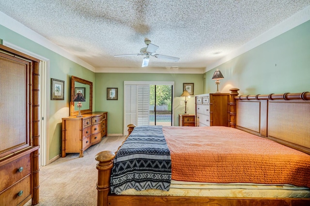 carpeted bedroom featuring ceiling fan, access to exterior, and a textured ceiling