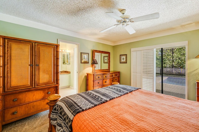 carpeted bedroom featuring access to exterior, a textured ceiling, ensuite bath, and ceiling fan