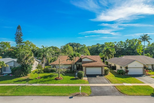 ranch-style house featuring a garage and a front yard